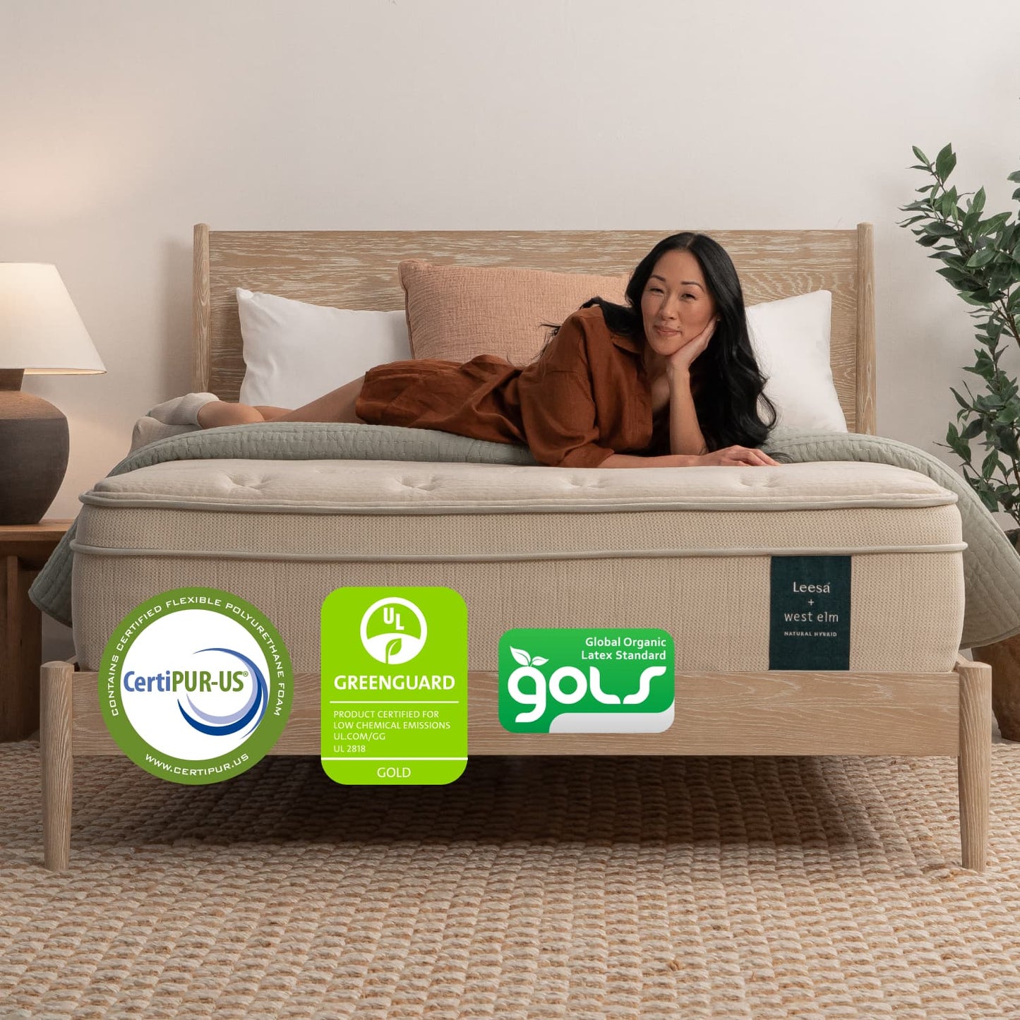 Woman on the Leesa Natural Hybrid Mattress in a bedroom.