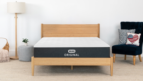 Bear Original mattress on natural wood bed frame in bright modern bedroom with bamboo accents for The Mattress Shop, showcasing product image Bear Original on the page: Sale Landing page.