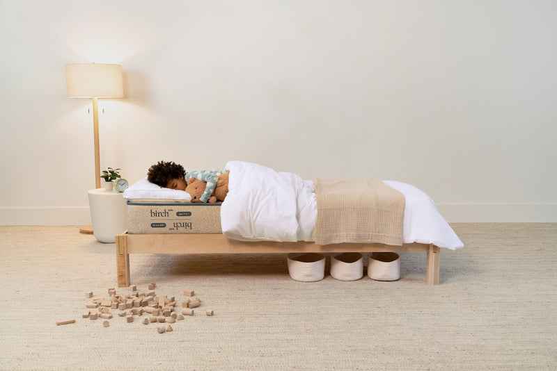 A child sleeping in the Birch Kids Natural Mattress