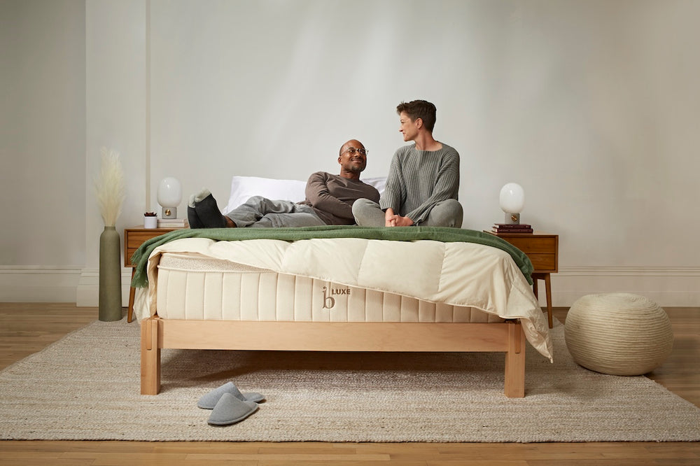 Two people seated on the Birch Luxe Natural Mattress