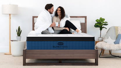 Couple relaxing together on Bear Elite Ultra HybridMattress, showcasing motion isolation and comfort