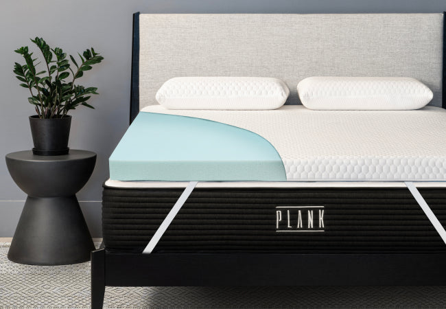 Plank Firm Topper with cutaway view showcasing its pressure-relieving foam layers for a firmer sleep surface. for The Mattress Shop, showcasing product image for Brooklyn Bedding Plank Firm Topper on the product page.
