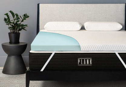 Plank Firm Topper with cutaway view showcasing its pressure-relieving foam layers for a firmer sleep surface.