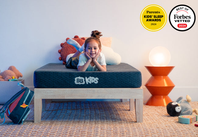 Brooklyn Bedding BB Kids mattress, Parents Kids Sleep Awards 2024 and Forbes Vetted best of 2024, girl lying on bed. for The Mattress Shop, showcasing product thumbnail image for Brooklyn Bedding BB Kids on the product page.
