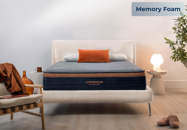 Brooklyn Bedding CopperFlex memory foam mattress on white upholstered bed frame in modern bedroom with warm accent decor for The Mattress Shop, showcasing product image Brooklyn Bedding CopperFlex® on the page: Best Hybrid Mattresses - Quiz Prominent CTA page.