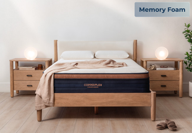 Brooklyn Bedding CopperFlex Pro memory foam mattress on wood bed frame in modern bright bedroom for The Mattress Shop, showcasing product image Brooklyn Bedding CopperFlex® Pro on the page: Best Hybrid Mattresses page.