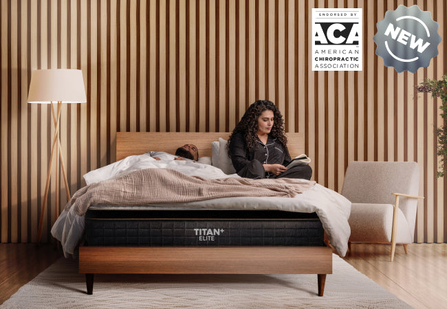 Brooklyn Bedding Titan Plus Elite new mattress, endorsed by American Chiropractic Association, couple in bedroom for The Mattress Shop, showcasing product thumbnail image for Brooklyn Bedding Titan® Plus Elite on the product page.