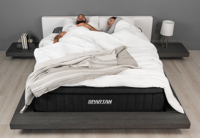 Brooklyn Bedding Spartan mattress with cooling features, couple sleeping comfortably together in modern bedroom. for The Mattress Shop, showcasing product image for Brooklyn Bedding Spartan on the product page.