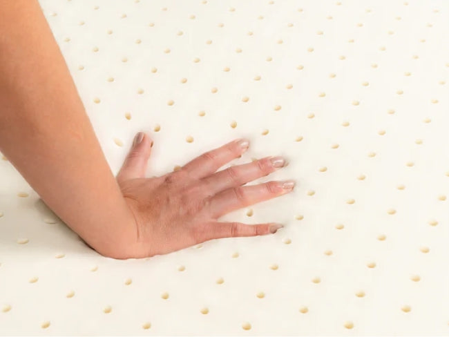 Talalay latex topper hand view showing its soft, supportive design for added comfort and pressure relief on your mattress. for The Mattress Shop, showcasing product image for Brooklyn Bedding Latex Topper on the product page.
