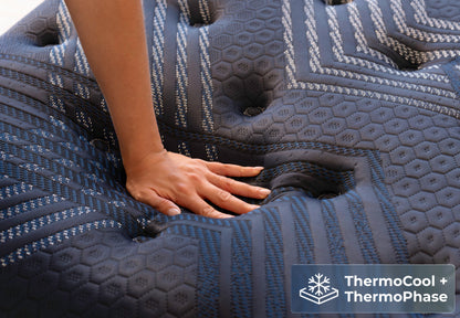 Brooklyn Bedding ThermoBalance mattress close-up with hand pressing in, featuring ThermoCool and ThermoPhase.