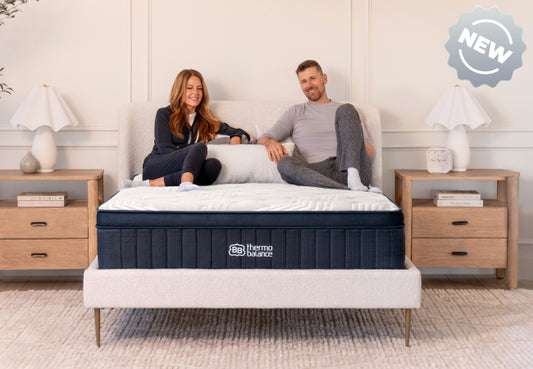 Brooklyn Bedding ThermoBalance LX new mattress, couple sitting together on white pillow top bed