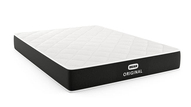 Bear Original mattress angled view showing white diamond-quilted top and black ribbed foundation for The Mattress Shop, showcasing product image Bear Original on the page: Best Memory Foam Mattresses page.