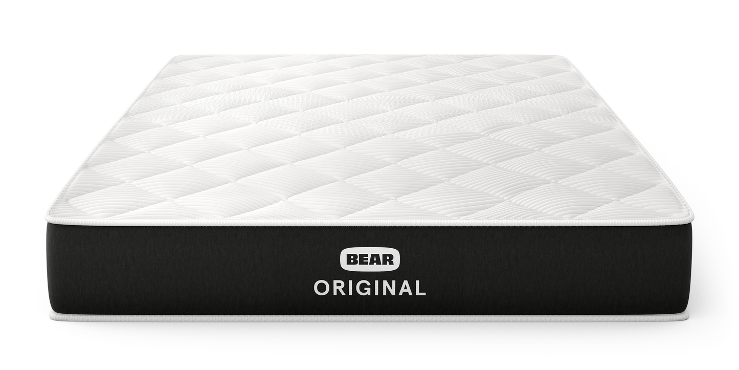 Bear Original mattress three-quarter front view with white quilted top and charcoal foundation for The Mattress Shop, showcasing product image for Bear Original on the product page.