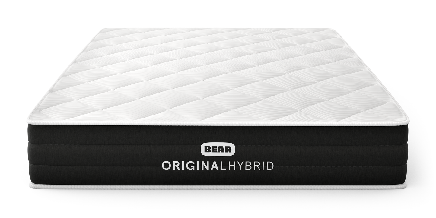 Bear Original Hybrid mattress three-quarter front view with white quilted top and black ribbed foundation for The Mattress Shop, showcasing product image for Bear Original Hybrid on the product page.