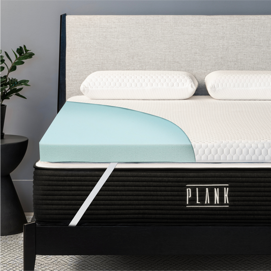 Plank Firm Topper with cutaway view showcasing its pressure-relieving foam layers for a firmer sleep surface.