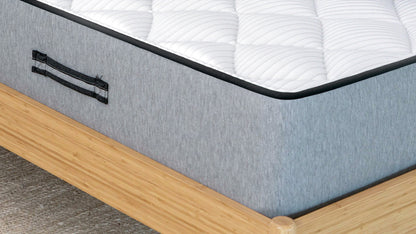 Bear Pro Foam mattress corner closeup showing gray fabric, carry handle, and white pillow top on wood frame