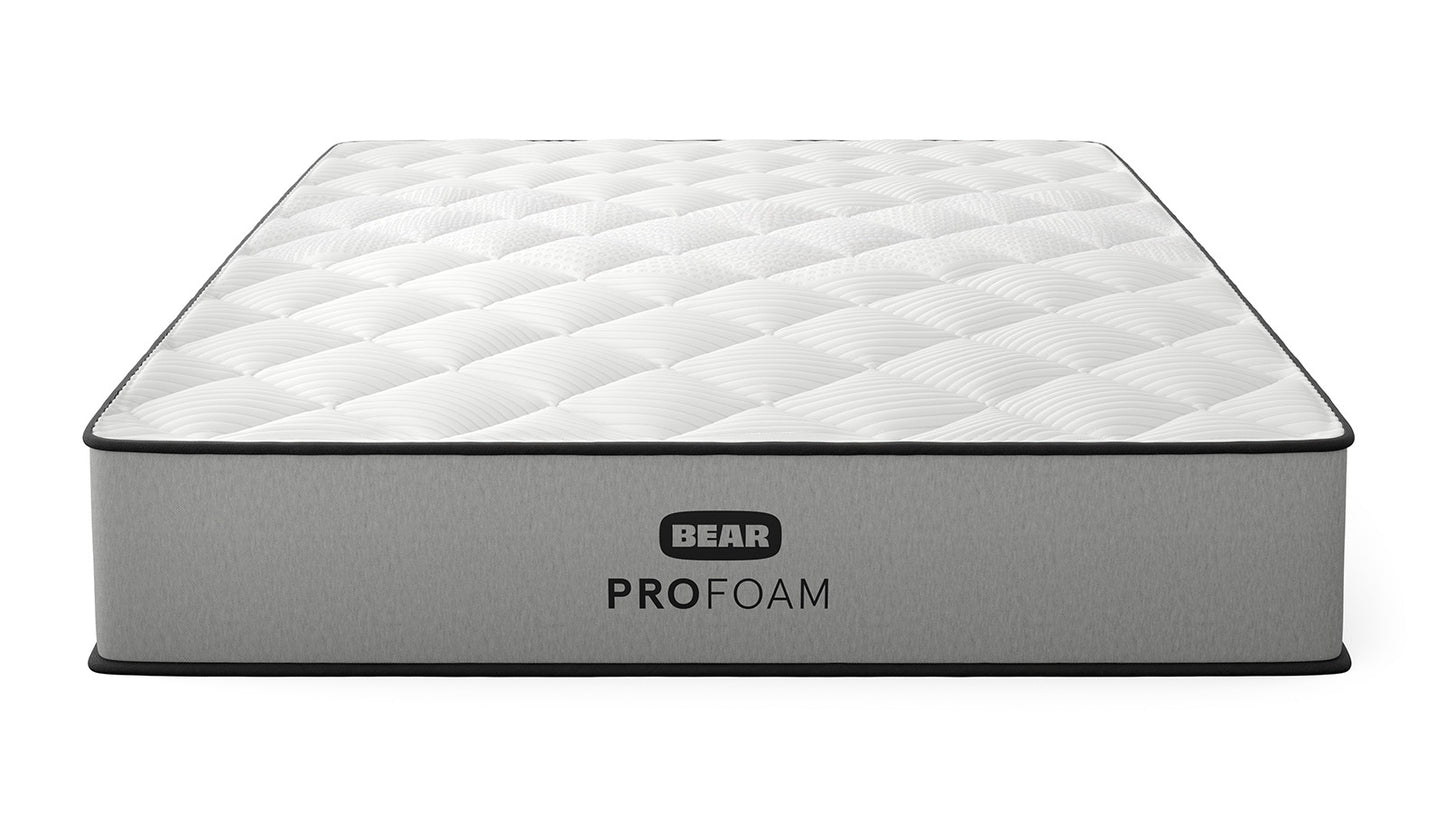 Bear Pro Foam mattress three-quarter front view with white quilted top and gray ribbed foundation for The Mattress Shop, showcasing product image for Bear Pro Foam on the product page.