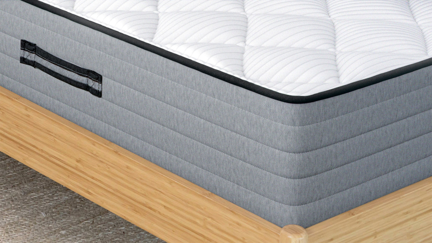 Bear Pro Hybrid Mattress corner closeup showing gray quilted border, carry handle, and white pillow top for The Mattress Shop, showcasing product image for Bear Pro Hybrid on the product page.