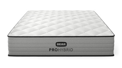 Bear Pro Hybrid Mattress three-quarter front view with white quilted pillow top and gray ribbed foundation