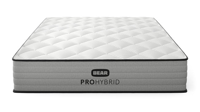 Bear Pro Hybrid Mattress three-quarter front view with white quilted pillow top and gray ribbed foundation for The Mattress Shop, showcasing product thumbnail image for Bear Pro Hybrid on the product page.