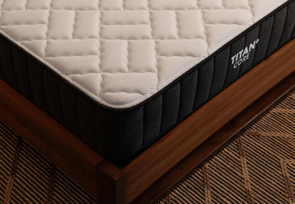 Brooklyn Bedding Titan+ Core mattress corner detail showing quilted top and side panel stitching on wood frame.