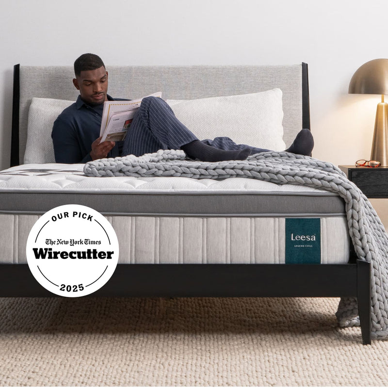 Man on the Leesa Legend Chill Hybrid Mattress in a bedroom.