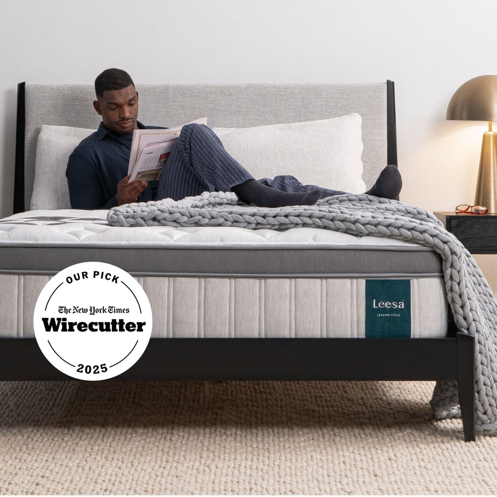 Man on the Leesa Legend Chill Hybrid Mattress in a bedroom.