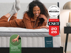 Woman laughing on Leesa Legend Chill mattress, named NYT Wirecutter's Our Pick and Best of CNET 2026. for The Mattress Shop, showcasing product image Leesa Legend Chill Hybrid Mattress on the page: Sale Landing page.