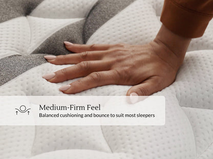 Hand pressing into quilted Leesa Legend Chill mattress cover, showing balanced medium-firm feel.