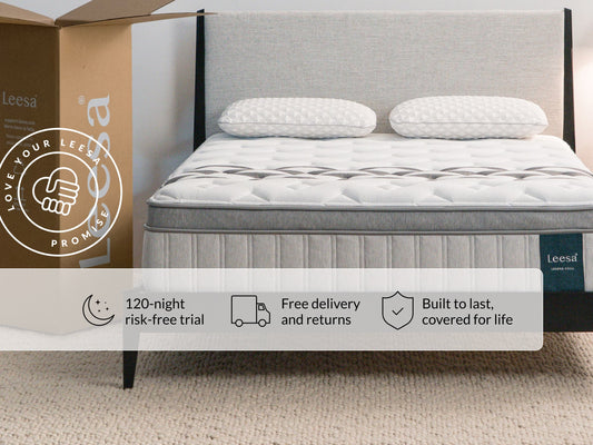 Leesa Legend Chill mattress on gray bed frame with pillows, shipping box shows Love Your Leesa Promise guarantee. for The Mattress Shop, showcasing product image for Leesa Legend Chill Hybrid Mattress on the collection page.