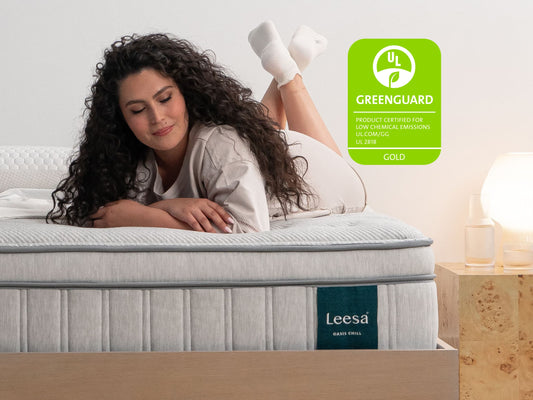 Woman lying on Leesa Oasis Chill mattress, UL Greenguard Gold certified for low chemical emissions. for The Mattress Shop, showcasing product image for Leesa Oasis Chill Hybrid Mattress on the page: About Leesa page.