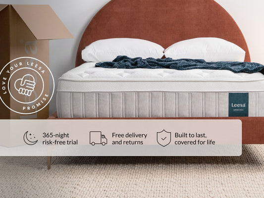 Leesa Sapira Chill mattress on bed with pillows and throw blanket, shipping box shows Love Your Leesa Promise. for The Mattress Shop, showcasing product image for Leesa Sapira Chill Hybrid Mattress on the collection page.
