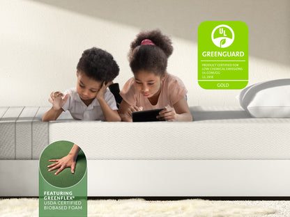 Two kids lying on Leesa Kids mattress with tablet, UL Greenguard Gold certified with biobased foam.