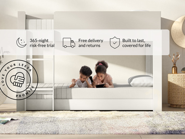Two kids lying on Leesa Kids mattress in bunk bed, shipping details show Love Your Leesa Promise guarantee. for The Mattress Shop, showcasing product image Leesa Kids Mattress on the page: Best Mattresses for Kids page.