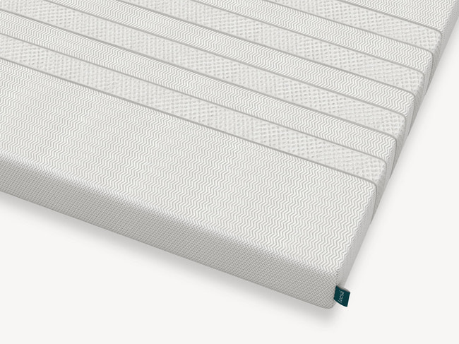 Corner detail of Leesa Kids mattress showing chevron-textured cover and brand label. for The Mattress Shop, showcasing product image Leesa Kids Mattress on the page: Best Mattresses for Kids page.