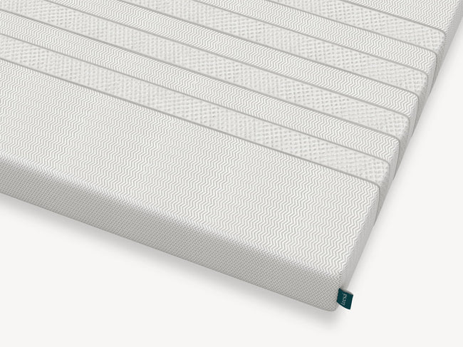 Corner detail of Leesa Kids mattress showing chevron-textured cover and brand label. for The Mattress Shop, showcasing product thumbnail image for Leesa Kids Mattress on the product page.
