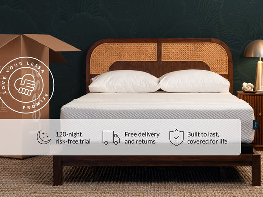 Leesa Legend Hybrid mattress on rattan bed frame with pillows, shipping box shows Love Your Leesa Promise. for The Mattress Shop, showcasing product image for Leesa Legend Hybrid Mattress on the collection page.