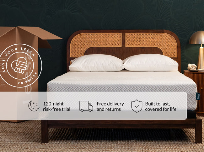 Leesa Legend Hybrid mattress on rattan bed frame with pillows, shipping box shows Love Your Leesa Promise. for The Mattress Shop, showcasing product thumbnail image for Leesa Legend Hybrid Mattress on the product page.