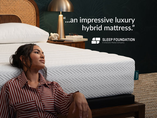 Woman sitting against Leesa Legend Hybrid mattress, Sleep Foundation quote on impressive luxury hybrid design. for The Mattress Shop, showcasing product image for Leesa Legend Hybrid Mattress on the collection page.