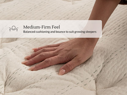 Hand pressing into Leesa Natural Essential mattress top, showing its medium-firm, balanced-cushioning feel.
