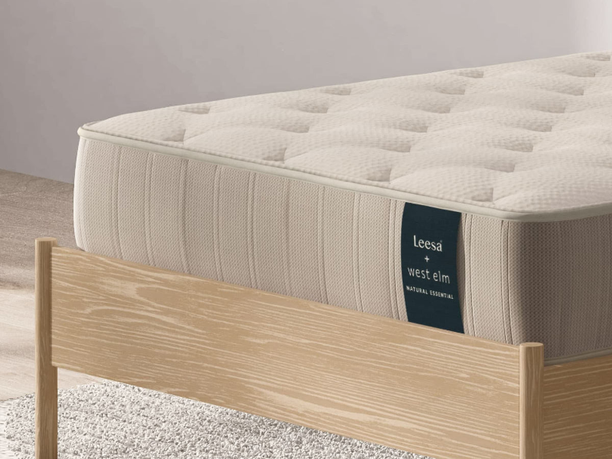 Close-up corner of Leesa Natural Essential mattress showing quilted cotton cover and tufted stitching detail. for The Mattress Shop, showcasing product image for Leesa Natural Essential Hybrid Mattress on the product page.