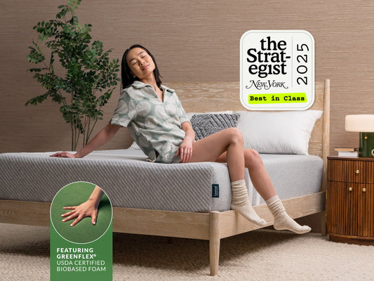 Woman sitting on Leesa Original Hybrid mattress, named Best in Class by The Strategist New York 2025. for The Mattress Shop, showcasing product image for Leesa Original Hybrid Mattress on the page: About Leesa page.