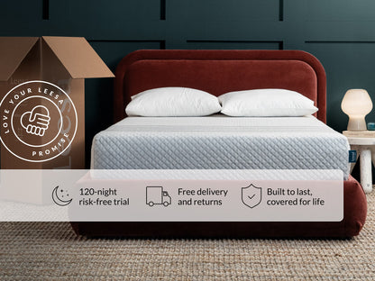 Leesa Sapira Hybrid mattress on red velvet bed frame with pillows, shipping box shows Love Your Leesa Promise.