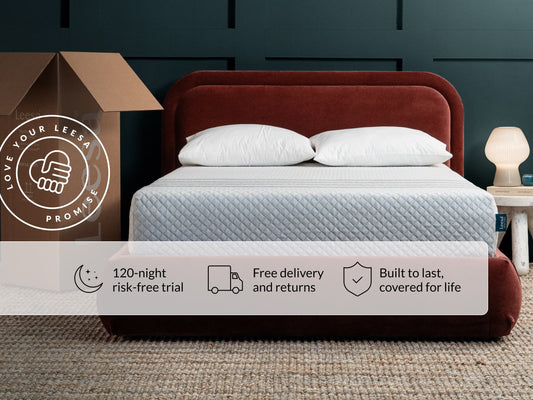 Leesa Sapira Hybrid mattress on red velvet bed frame with pillows, shipping box shows Love Your Leesa Promise. for The Mattress Shop, showcasing product image for Leesa Sapira Hybrid Mattress on the collection page.
