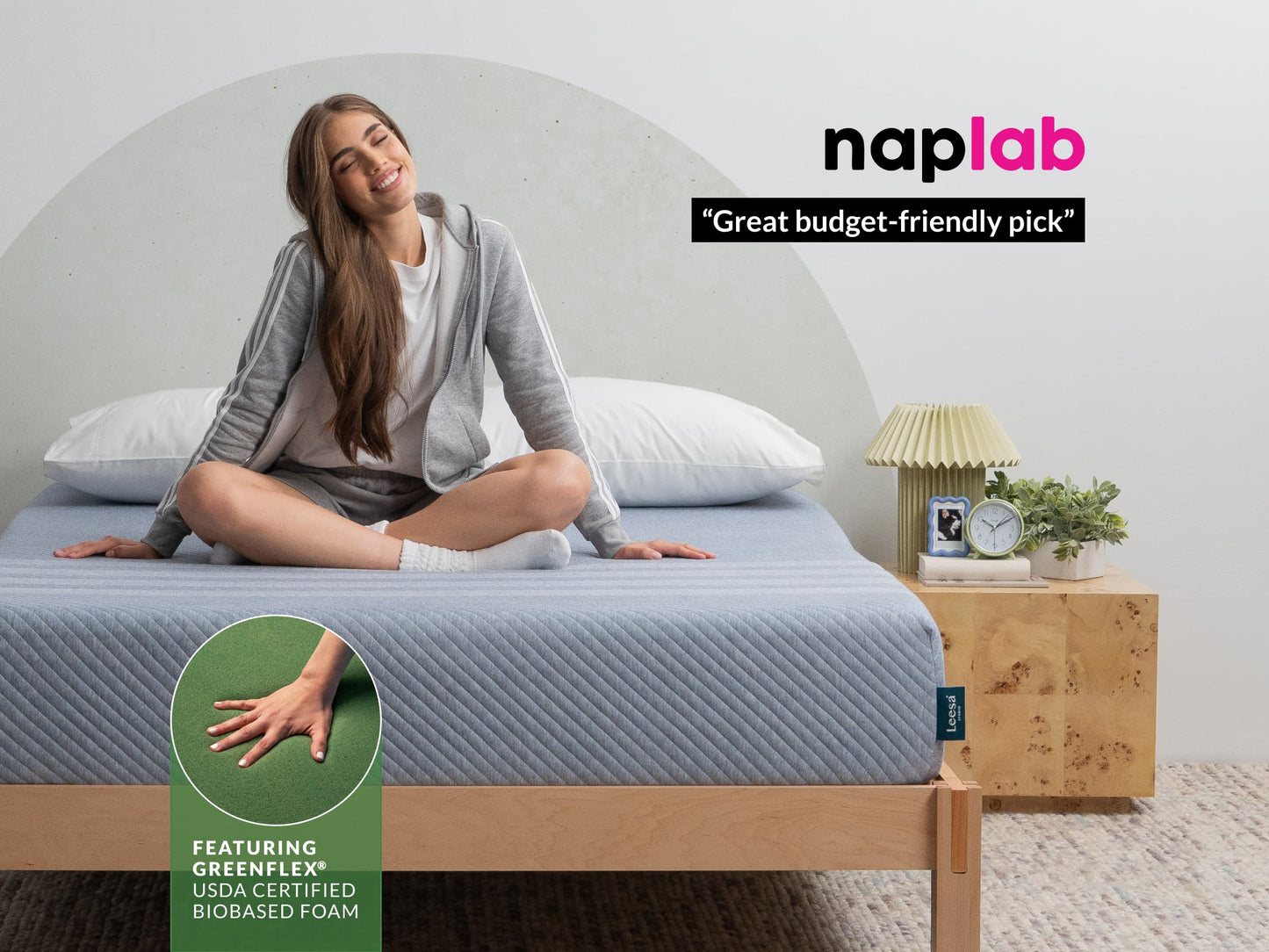 Woman relaxing on Leesa Studio mattress with blue cover, Naplab calls it a great budget-friendly pick. for The Mattress Shop, showcasing product image for Leesa Studio Mattress on the product page.