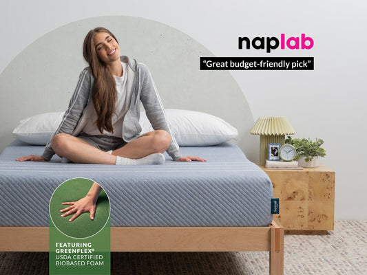 Woman relaxing on Leesa Studio mattress with blue cover, Naplab calls it a great budget-friendly pick. for The Mattress Shop, showcasing product image for Leesa Studio Mattress on the page: About Leesa page.