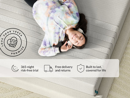 Teen in tie-dye hoodie and headphones relaxing on a Leesa mattress; 365-night trial, free delivery, lifetime coverage