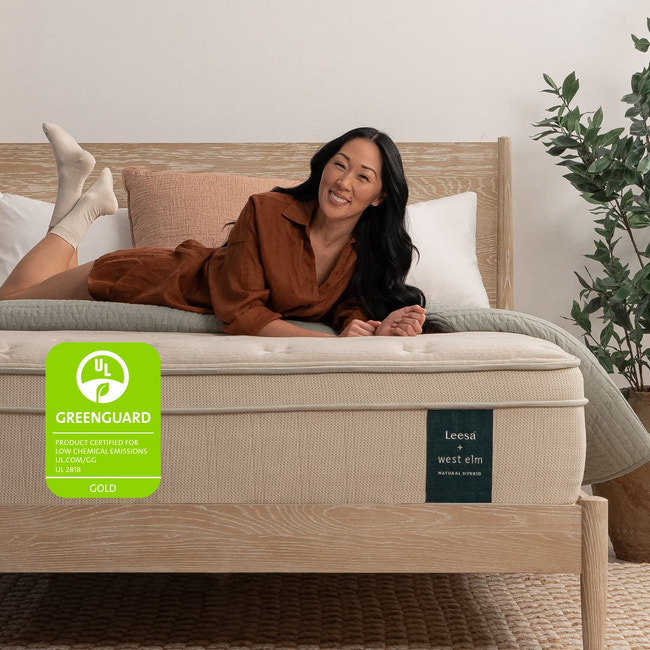 Woman on the Leesa Natural Hybrid Mattress in a bedroom. for The Mattress Shop, showcasing product image Leesa Natural Hybrid Mattress on the page: Best Natural / Organic Mattresses page.