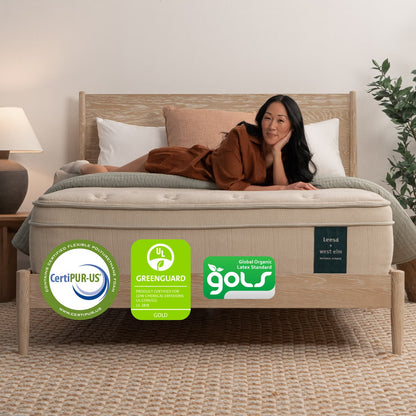 Woman on the Leesa Natural Hybrid Mattress in a bedroom.