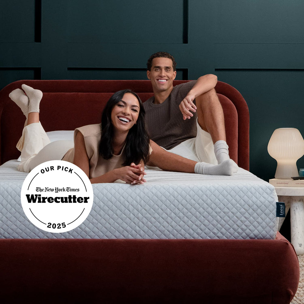 Couple on the Leesa Sapira Hybrid Mattress in a bedroom.